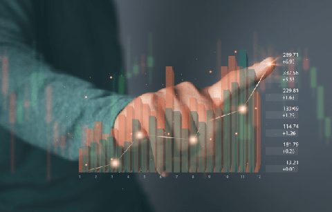 Ein ausgestreckter Finger zeigt auf ein leuchtendes Punktdiagramm mit Balkendiagramm und Zahlenwerten im Vordergrund.